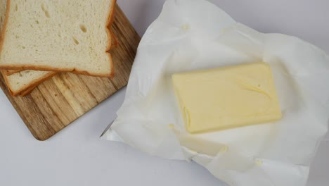 slice of a butter on a paper on table