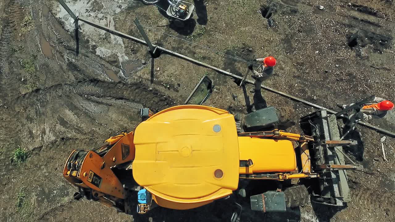 Tractor On Construction Site. Aerial view of site preparation and construction in progress