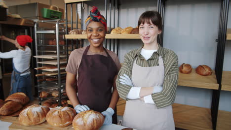 portrait of cheerful multiethnic female bakers at work