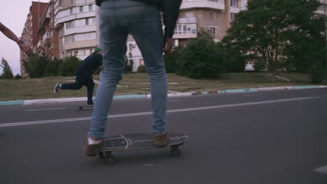 group of young people skateboarding on the road in the early morning, cinematic shot, slow motion