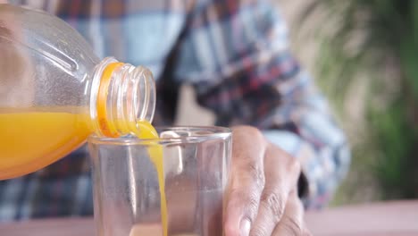 pouring orange juice into a glass