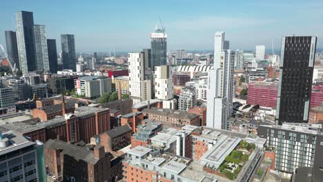 aerial drone flight over the mancunian way and oxford road rooftops with a revealing view of deansgate towers