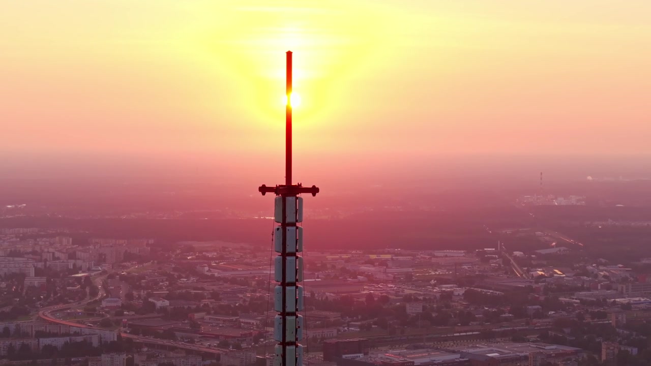 Rotazione di un drone intorno alla Torre della Radio e TV di Riga al tramonto nello skyline della Lettonia