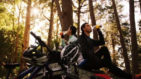 mountain biking couple drinking water