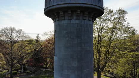 rising aerial up washington tower in watertown to reveal afternoon sun over boston suburbs