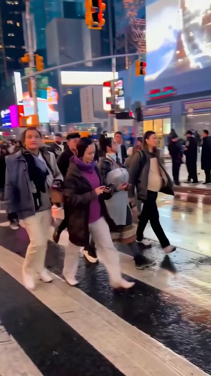 Crowd of People Walking Across a Busy City Crosswalk at Evening