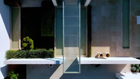 aerial topshot view of a luxurious russian villa's entrance porch with spacious glass facade