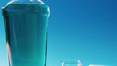 video of close up of toothbrush, paste and mouthwash on blue background