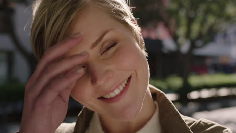 close up portrait of beautiful blonde woman smiling cheerful running hand through hair feeling optimistic