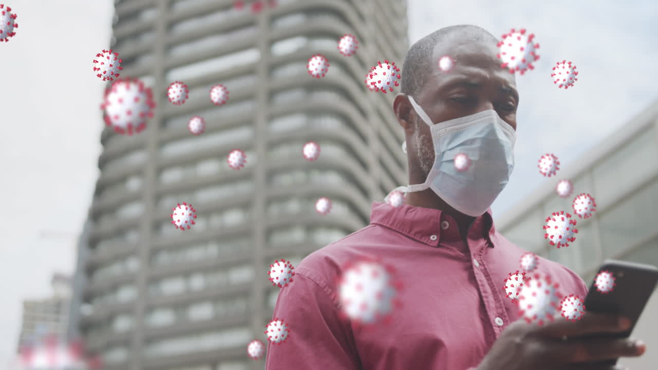 코로나19 세포가 아프리카계 미국인에 대해 떠다니고 있습니다. 스마트폰을 사용하는 얼굴 마스크를 쓰고 있는 노인입니다.