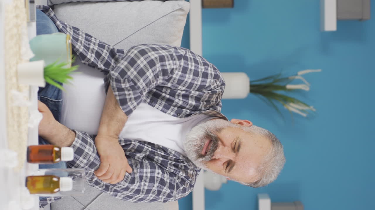 Vertical video of Old man experiencing pain in bones.