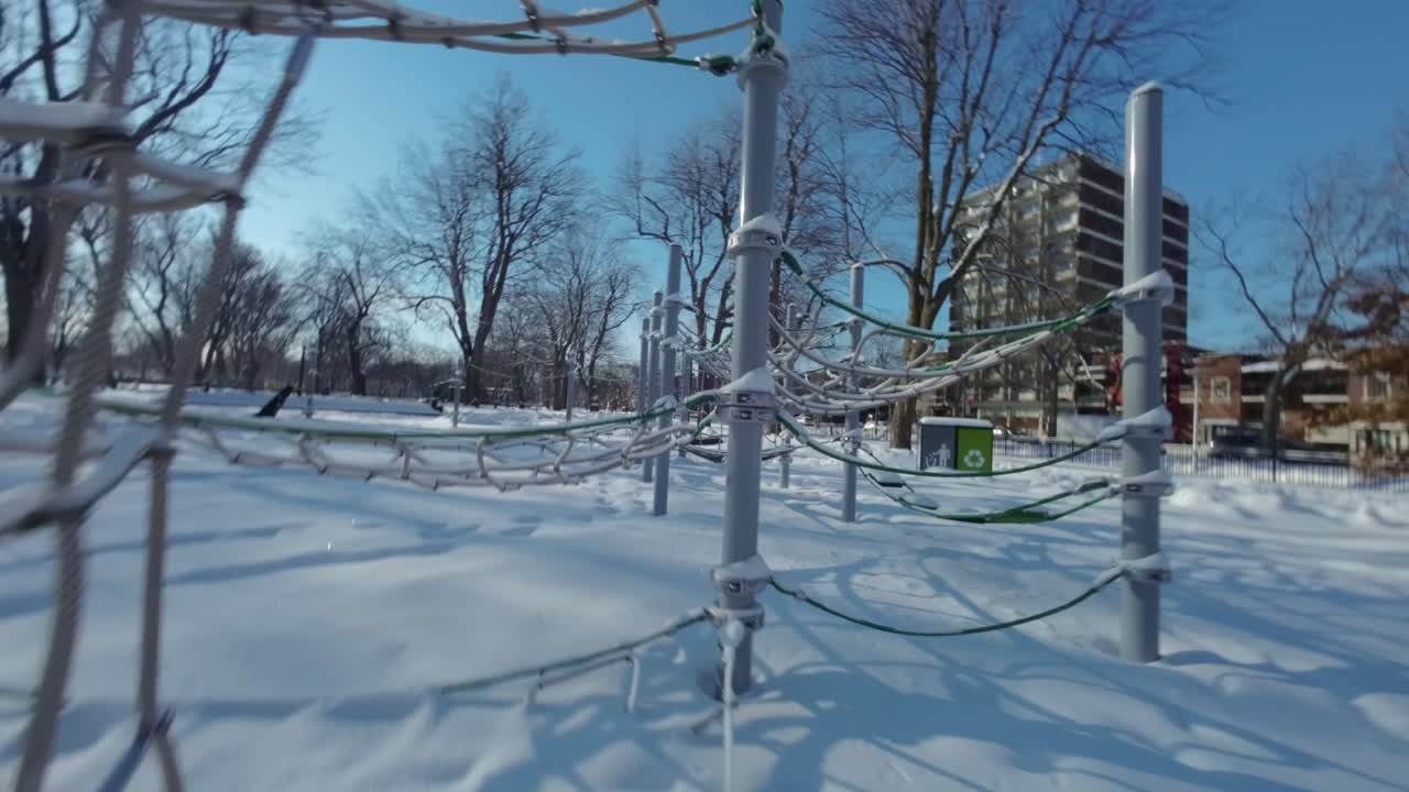 Drone Fpv shot across various obstacles in the playground during winter in Montreal, Canada