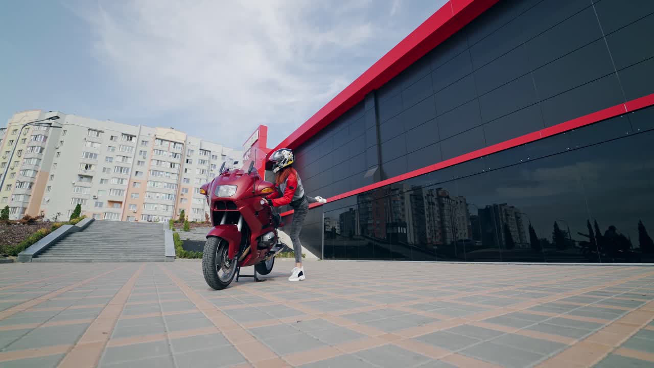 Extreme woman on motorbike. Beautiful young woman motorcyclist sitting on motorcycle with helmet