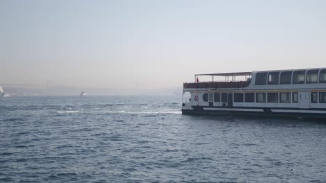 a white ferry boat is sailing on a calm blue ocean