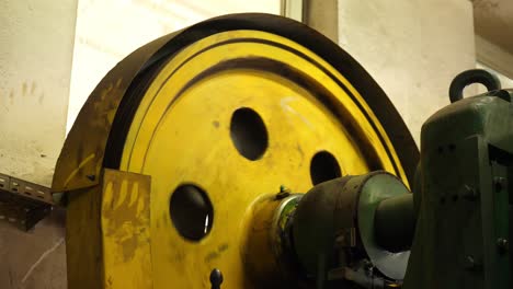 industrial rhythm: machine wheel turns, shaping industry elements with precision in this vivid stock footage snapshot