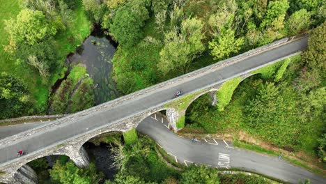 ireland epic locations durrow viaduct on the waterford greenway cyclists admiring the view of the river and roadway winding its way under the bridge, tourist attraction in ireland