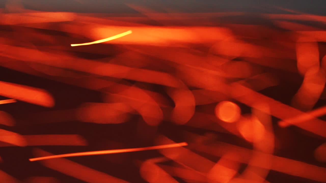 A blurry trace of some sparks of fire in the chimney. Chaotic movement of burning particles