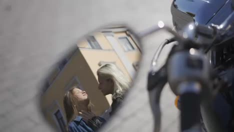 Mirror-reflection-on-motobike---two-lesbian-girls-kissing-on-the-city-street