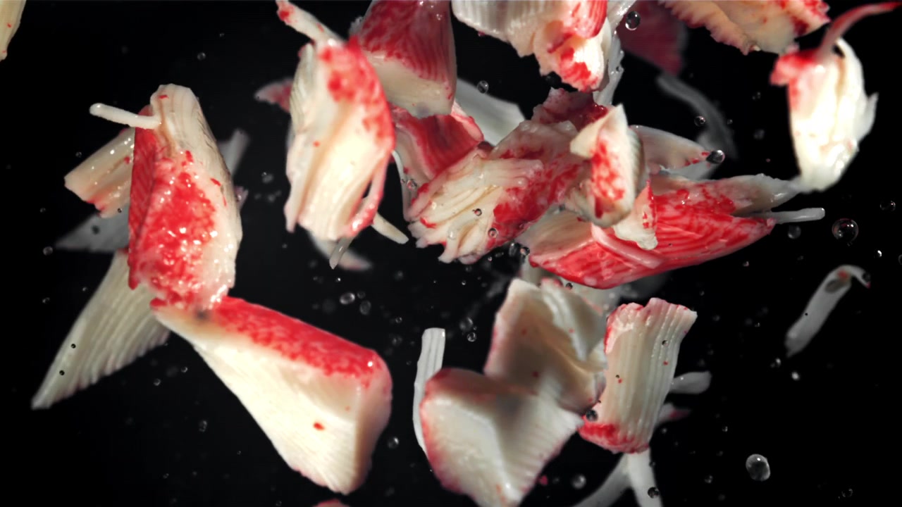 Imitation Crab Meat Falling in Slow Motion with Water Drops