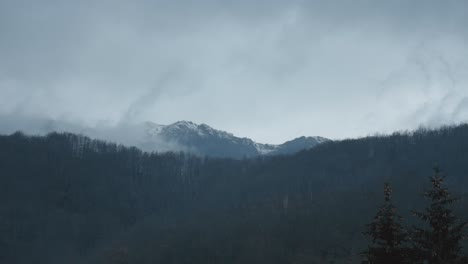 clouds time lapse over mountain, trees and fog