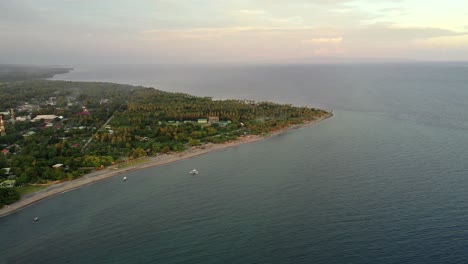 Aerial-View-Of-Negros-Oriental-Island-With-Boats-Sailing-On-Calm-Ocean-At-Sunrise-In-Philippines---Apo-Island-By-Sulu-Sea