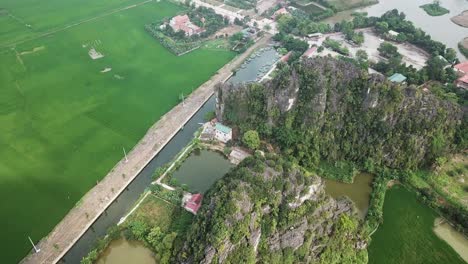 Static-drone-shot-of-a-small-town-with-houses-on-a-canal-or-river