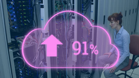 Animation-of-cloud-with-increasing-number-over-smiling-caucasian-woman-sitting-at-servers