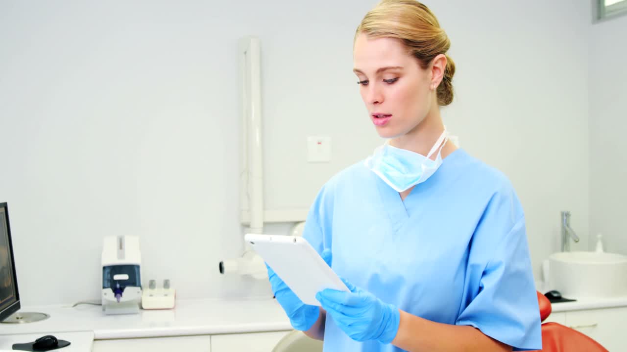 Female nurse using digital tablet in clinic