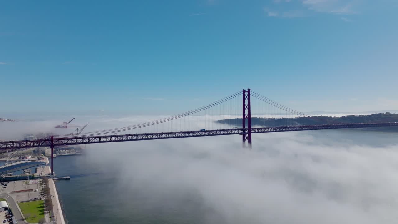 Drone shot of the fog under the big bridge in Lisbon.