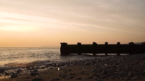 industrial drainage pipe on seashore rocky beach environmental