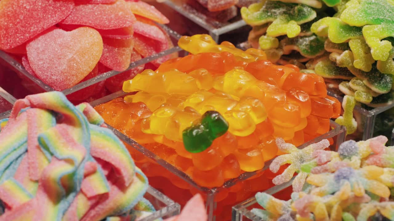 Colorful gummy candies in clear containers are captivating and tempting, appealing to the eyes and taste buds