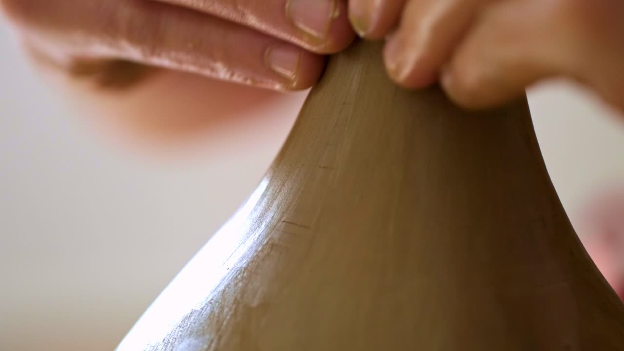 Mastering the Art of Pottery: A Close-Up Journey of Crafting a Beautiful Ceramic Vase from Clay with Skillful Hands and Attention to Detail