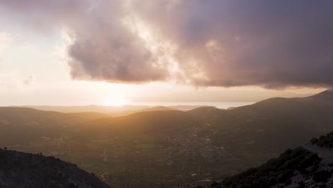 sunset over a valley with mountains and coastline