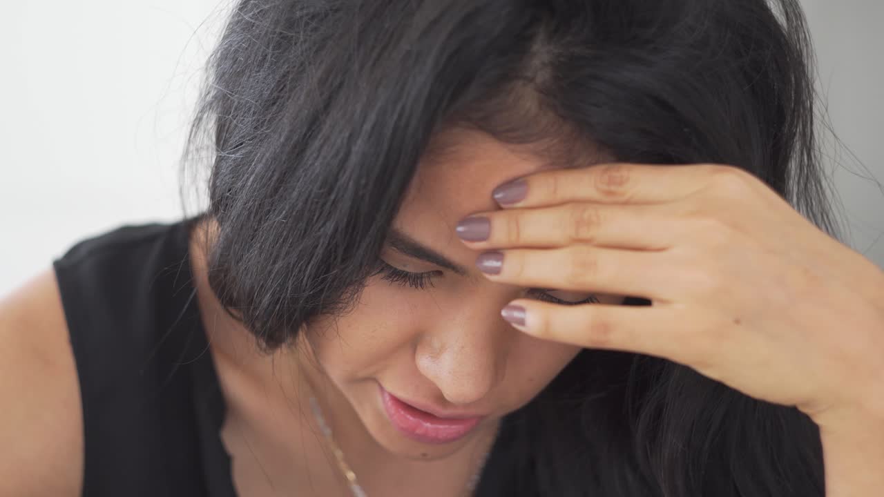 hermosa joven latina disfruta de la música y sonríe hacia la cámara mientras trabaja