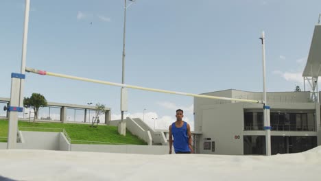 Mixed-race-athlete-doing-high-jump