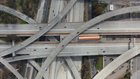 AERIAL:-Spectacular-Overhead-follow-Shot-of-Judge-Pregerson-Interchange-showing-multiple-Roads,-Bridges,-Highway-with-little-car-traffic-in-Los-Angeles,-California-on-Beautiful-Sunny-Day