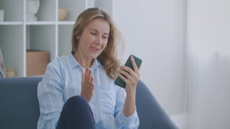 portrait of happy business woman enjoy success on mobile phone at home office. closeup joyful girl reading good news on phone in slow motion. surprised lady celebrating victory on phone in apartment.
