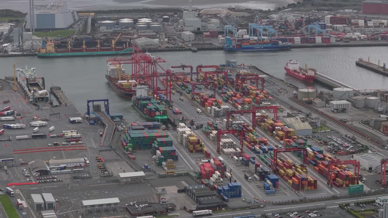 Busy container terminal with cranes and cargo ships at Dublin Port, Ireland