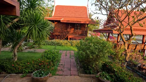 peaceful garden scene with traditional thai house