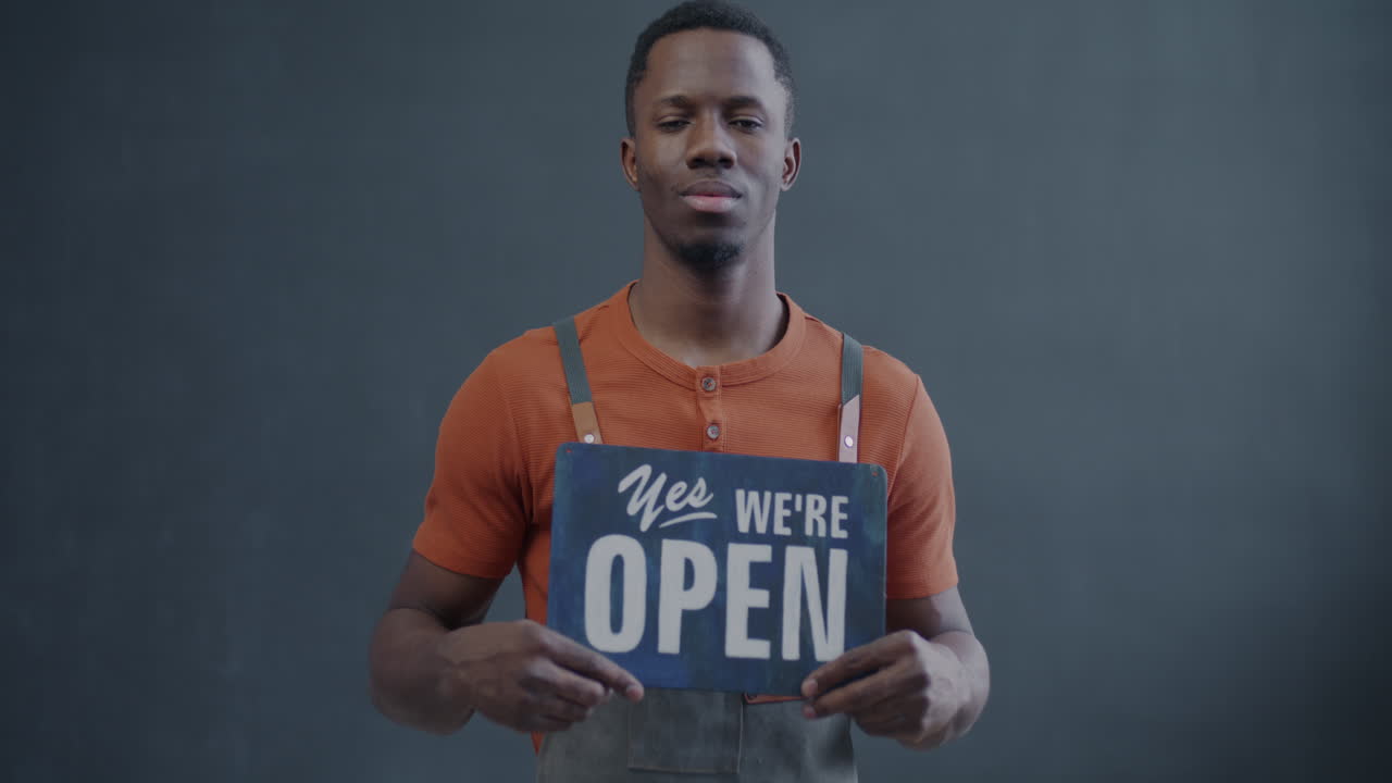 Business Owner Holding Open Sign