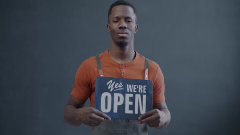 business owner holding open sign