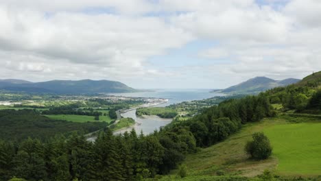 Aerial-flight-of-the-flagstaff-viewpoint-area,-countryside,-Newry,-with-Warrenpoint-town-in-the-distance-during-the-summer