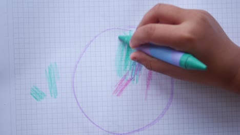 child drawing with crayons