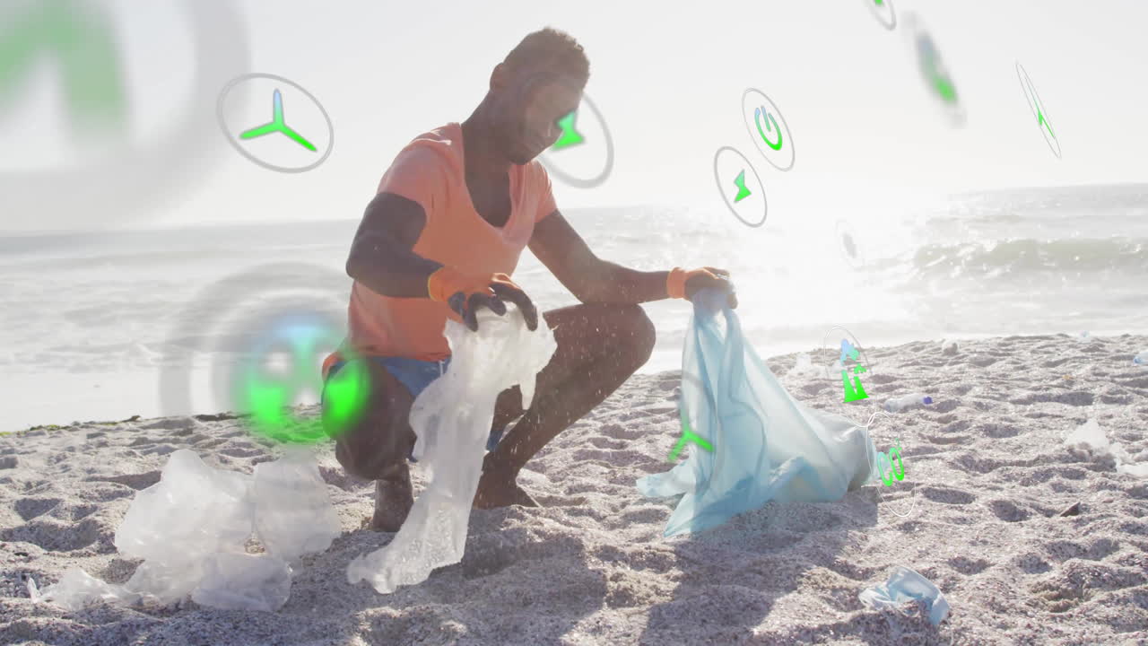 Man volunteering collecting plastic litter on beach for environment, showing floating eco icons