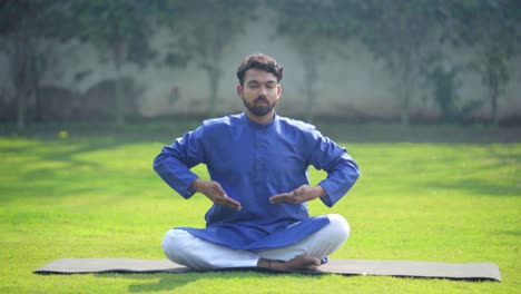 Indian-man-doing-breathe-in-breathe-out-yoga-exercise