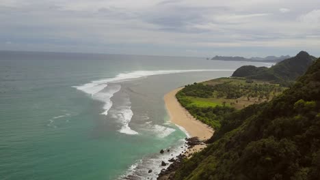 A-remote-surf-beach-at-Pantai-Selong-Belanak,-Lombok,-Aerial-shots-during-day-light