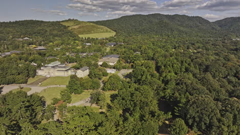 Nara-Japan-Aerial-v2-flyover-Noboriojicho-capturing-National-Museum,-Buddhist-Temples-in-the-park-and-its-surrounding-mountain-landscape-and-urban-cityscape---Shot-with-Mavic-3-Pro-Cine---October-2023