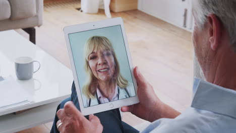 Mature-Man-Having-Online-Consultation-With-Female-Doctor-At-Home-On-Digital-Tablet