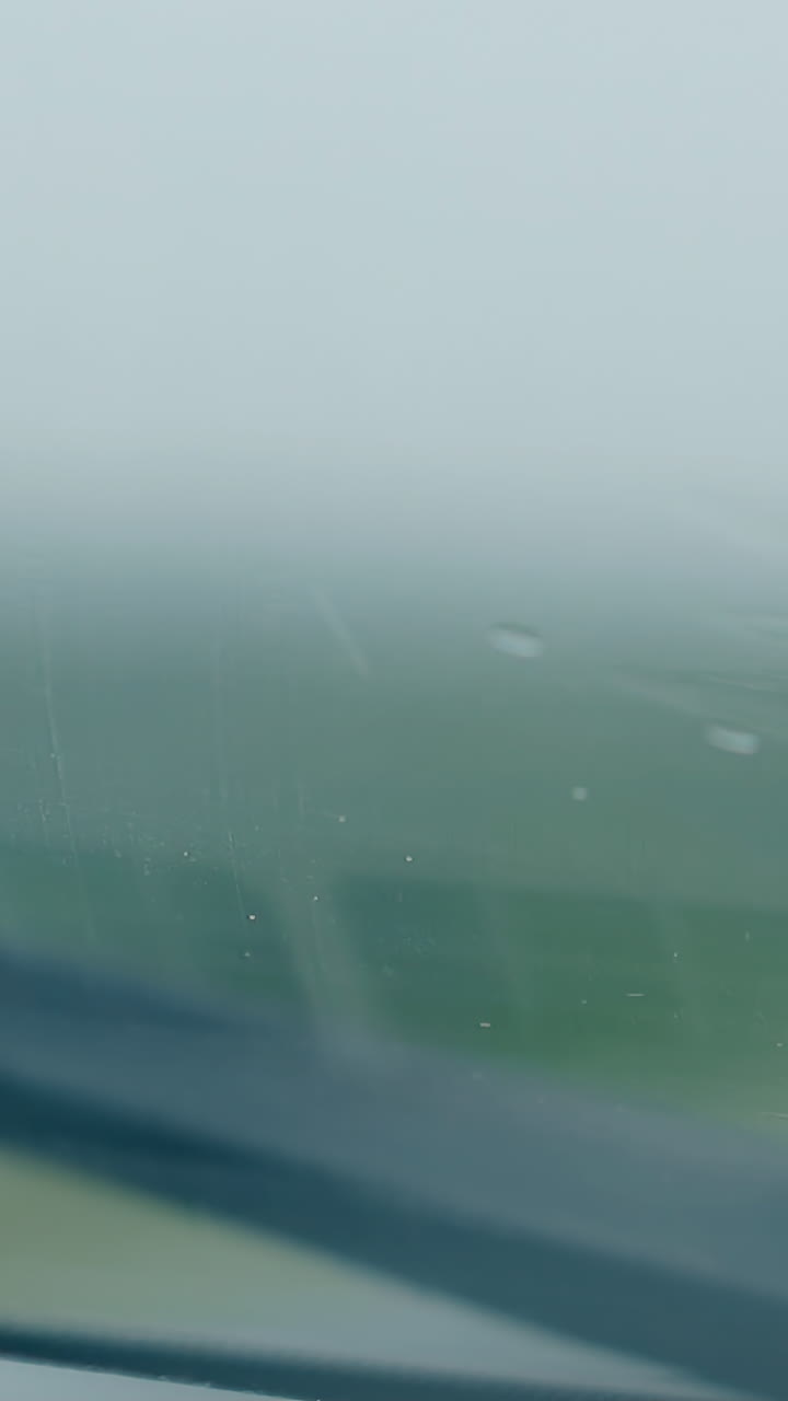 inspiring close view mechanical car wiper cleans small drops on automobile windscreen under rain