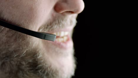 select focus closeup: caucasian man speaks into communication headset